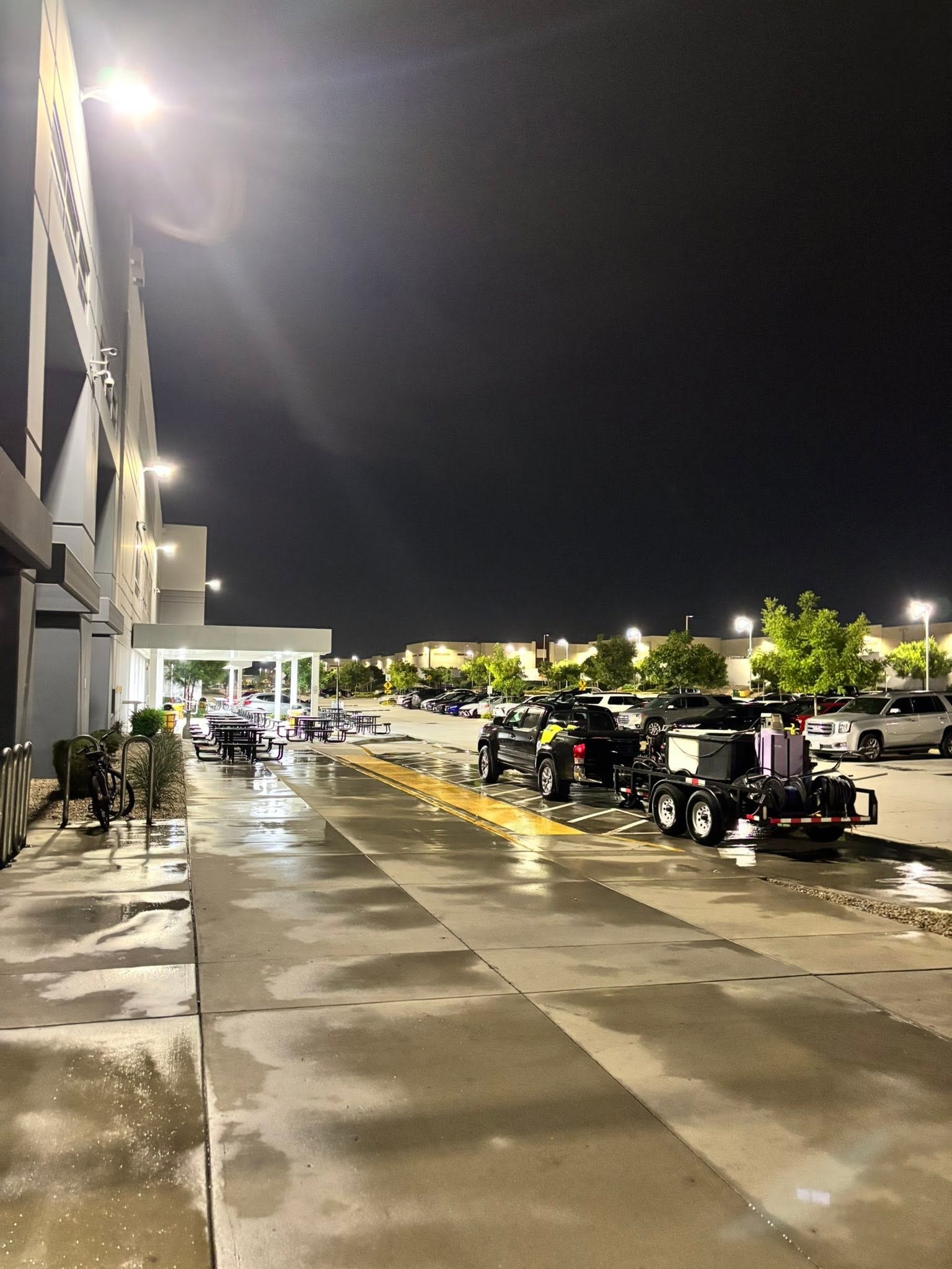 Night sidewalk wash — power trailer on site
